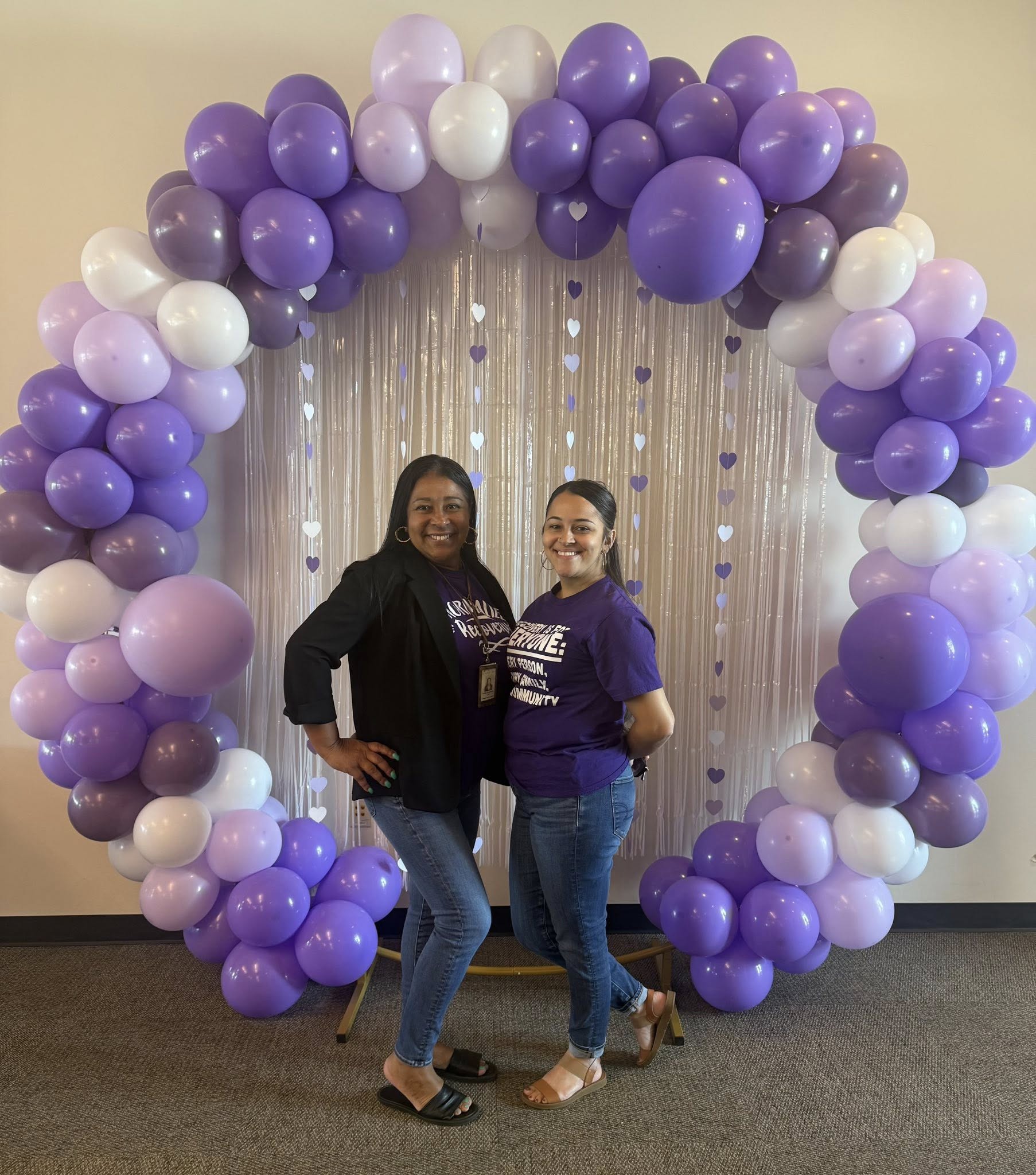 Two members at purple balloon celebration