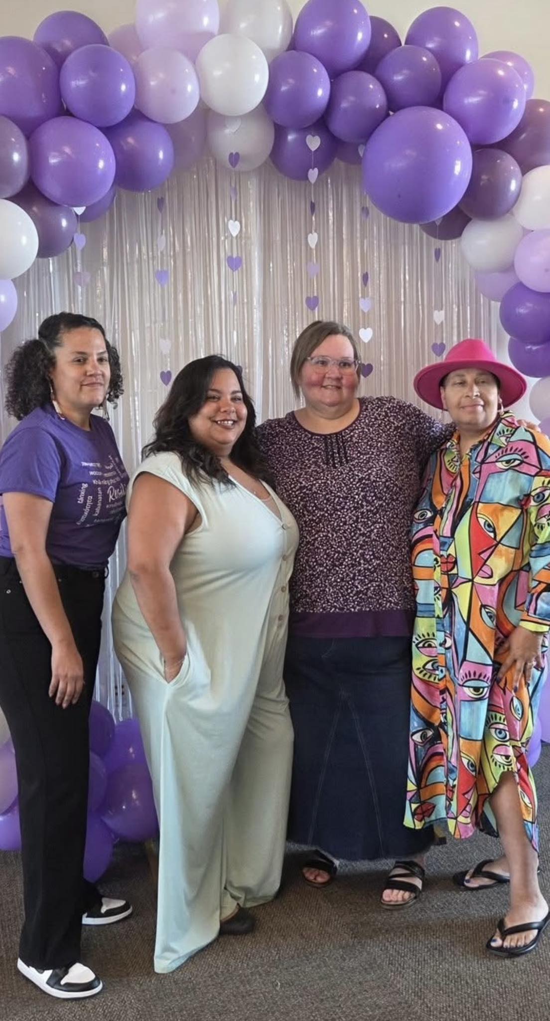 Community members at purple balloon arch